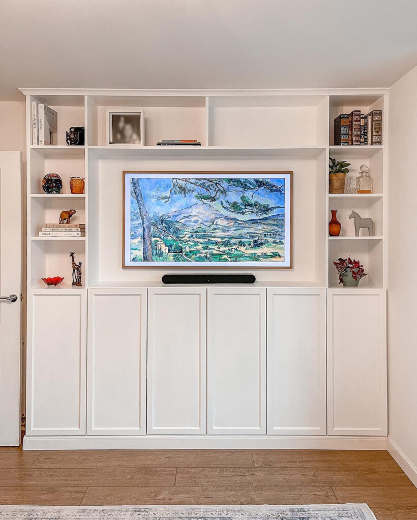finished ikea billy bookcase media wall with samsung frame tv soundbar and styled shelves