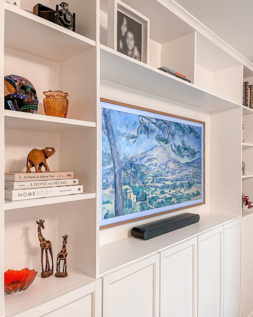 close up of styled shelves on ikea billy bookcase media wall with books and decorative objects