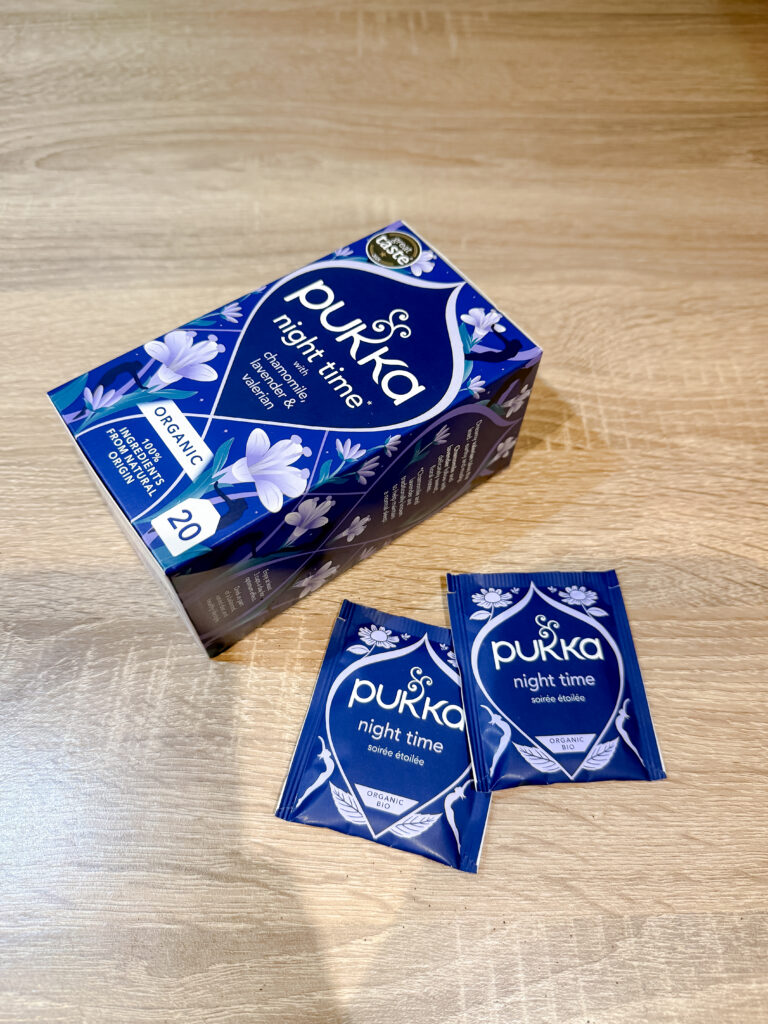 Pukka Night Time tea box beside two sealed organic teabag sachets