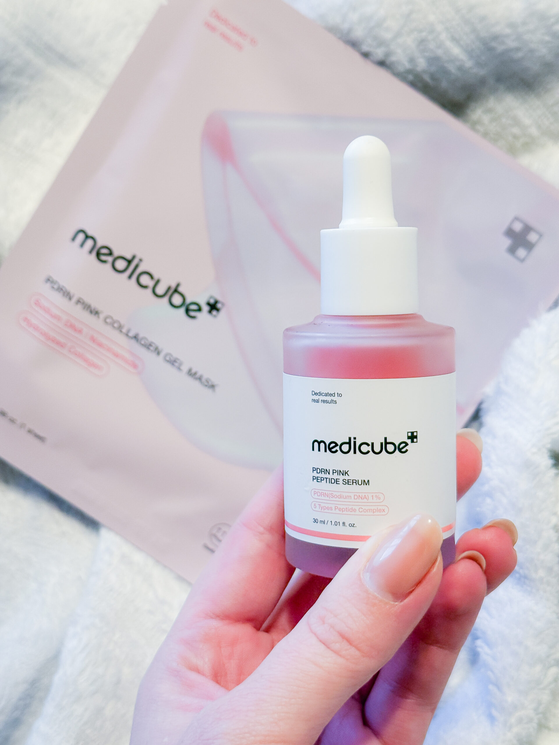 Medicube PDRN pink collagen gel mask sachet next to the peptide serum bottle