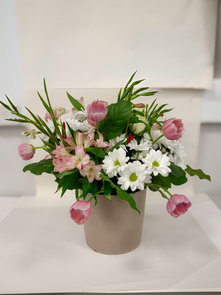 a large flower arrangement made with chicken wire and tulips