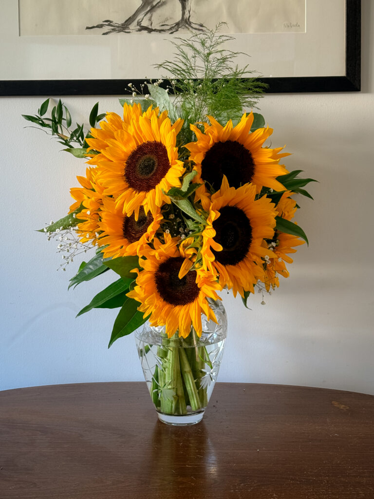 8 sunflowers in a big kitchen bouquet