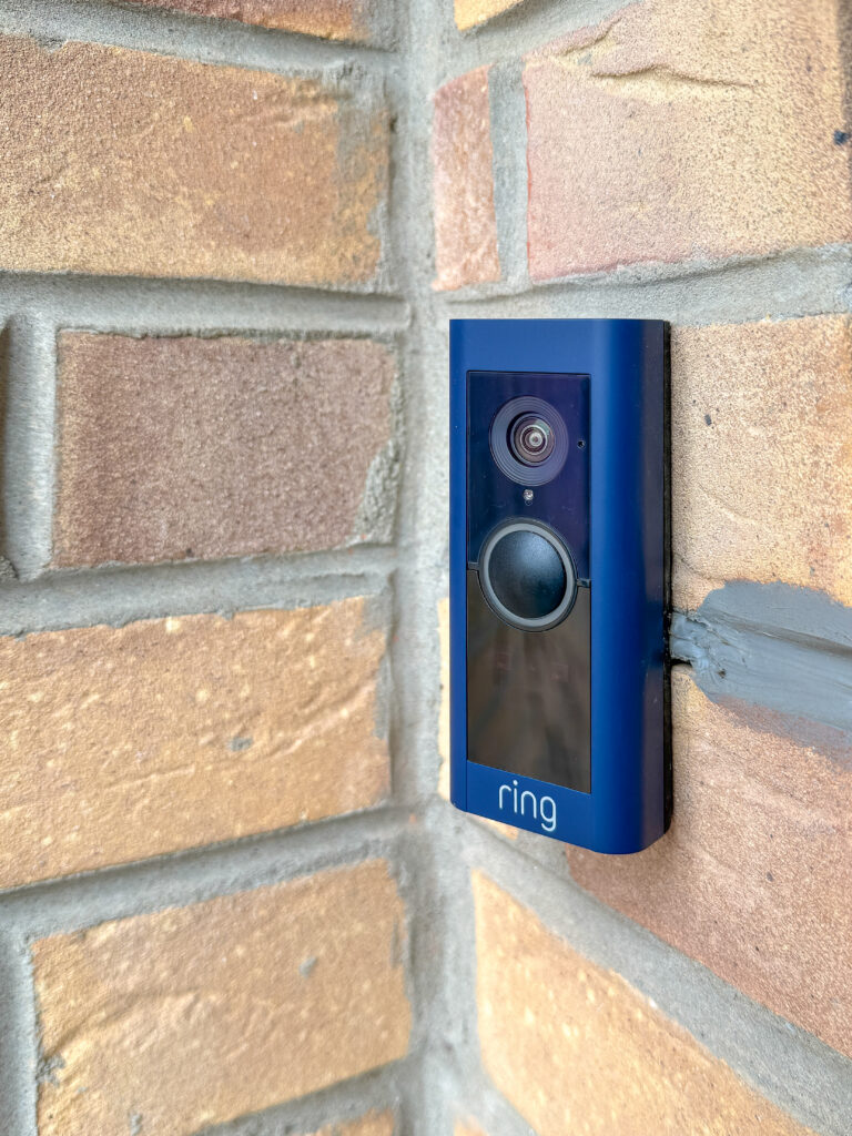 navy ring video doorbell on a modern brick house