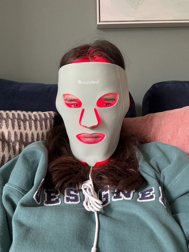 wearing the nanoleaf led mask on red light mode in a living room