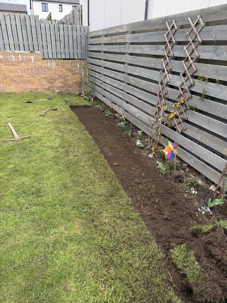 digging out a flowerbed in a new-build garden