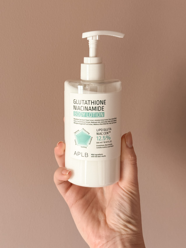 Hand holding APLB Glutathione Niacinamide Body Lotion pump bottle, 300ml