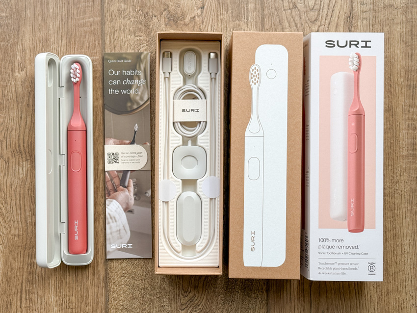 Unboxing the SURI Pro 2.0 toothbrush on a wooden surface