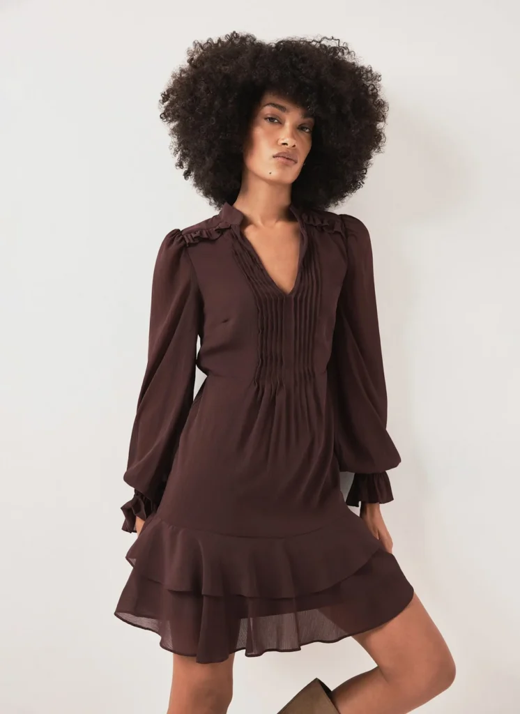 Model wearing the Mint Velvet burgundy ruffle mini dress
