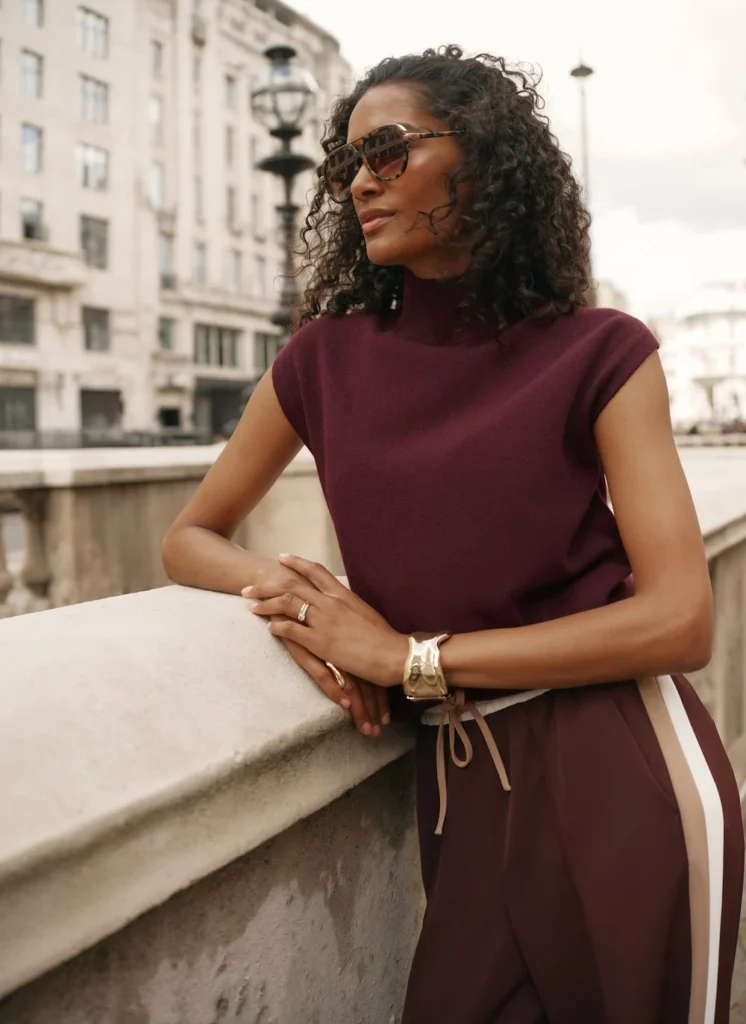 Model wearing the Mint Velvet burgundy wool-blend sleeveless knit top