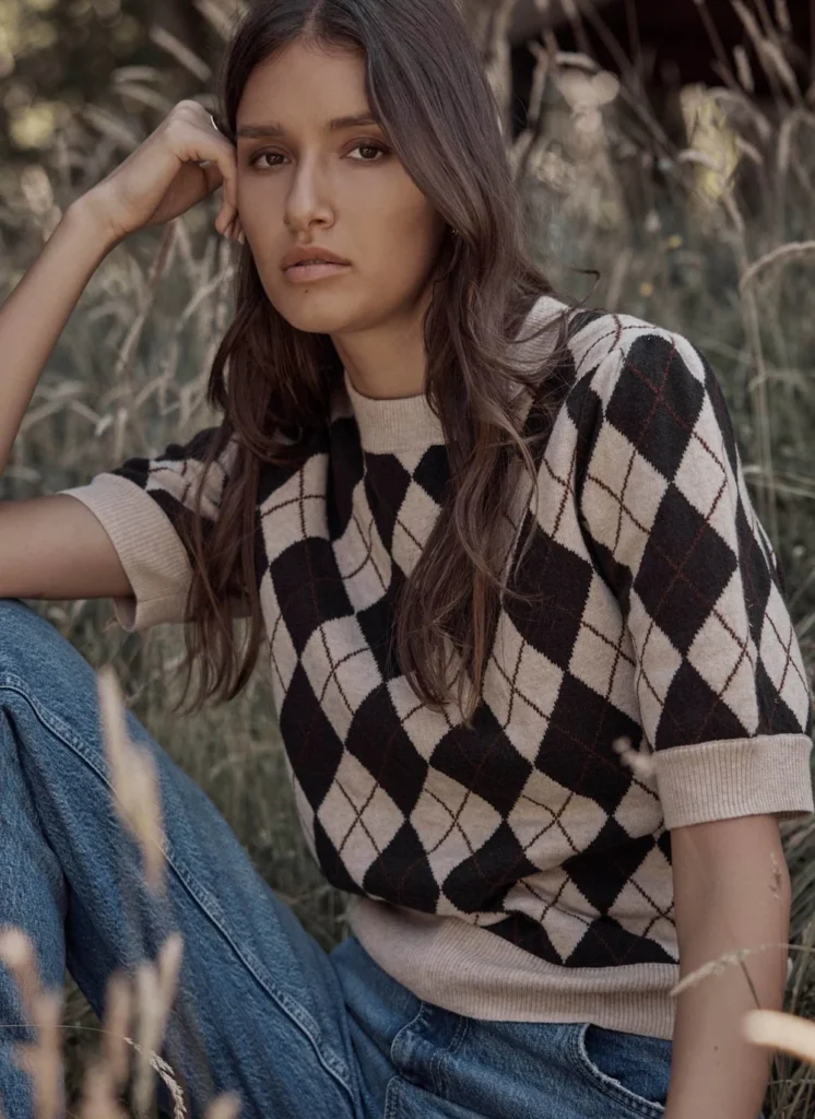 Model wearing the Mint Velvet neutral argyle knit top